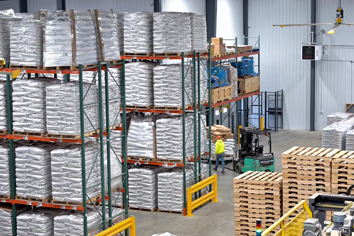 Malteurop Employee walking amongst Rows of Malt Bags